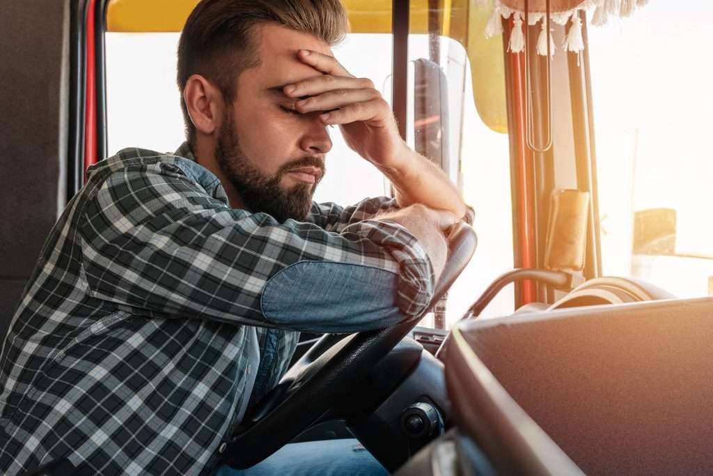 Portrait of tired truck driver feeling sleepy.