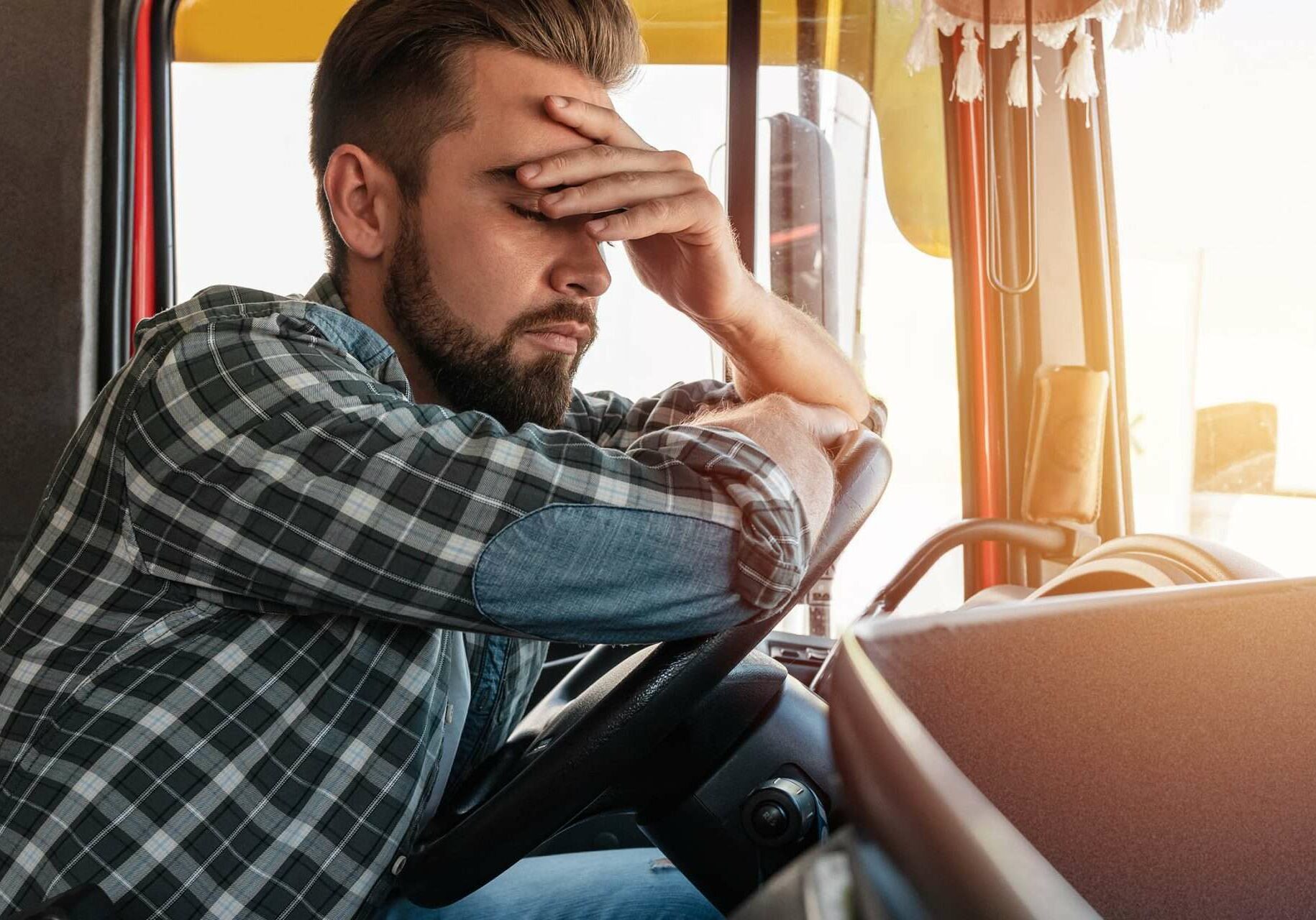 Portrait of tired truck driver feeling sleepy.